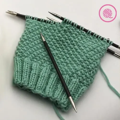needle knit edelweiss hat in progress on DPNs
