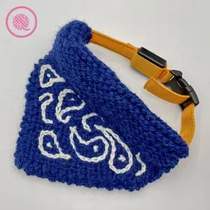 needle knit pet bandana with surface crochet paisley design