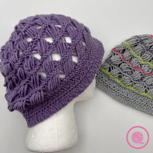 Breezy Retreat hat shown in solid purple or gray with contrast stripes